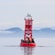 Sea lions and seabirds resting on a buoy in calm water with mountains in the distance